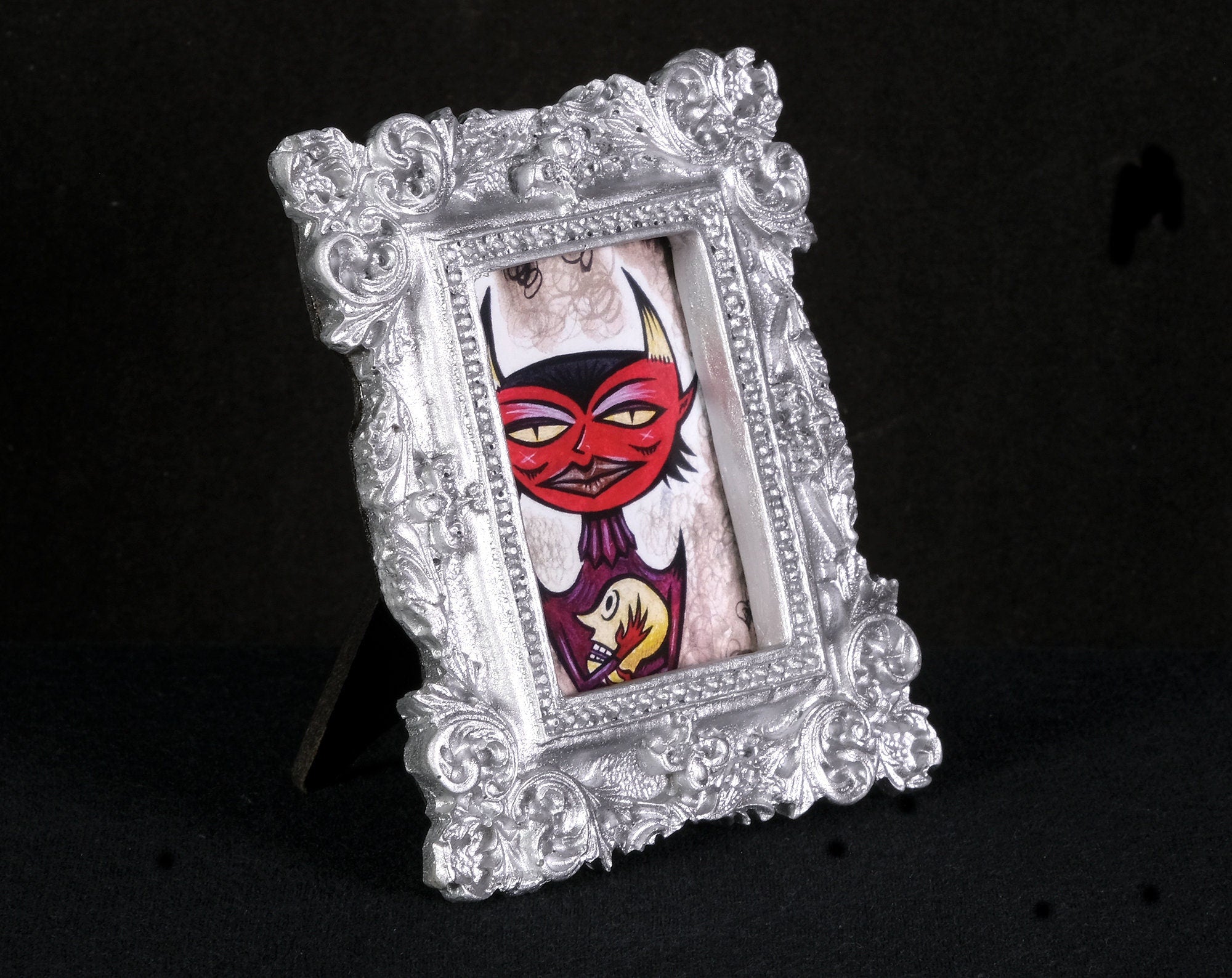 Head Holder Tiny Demon Framed Print