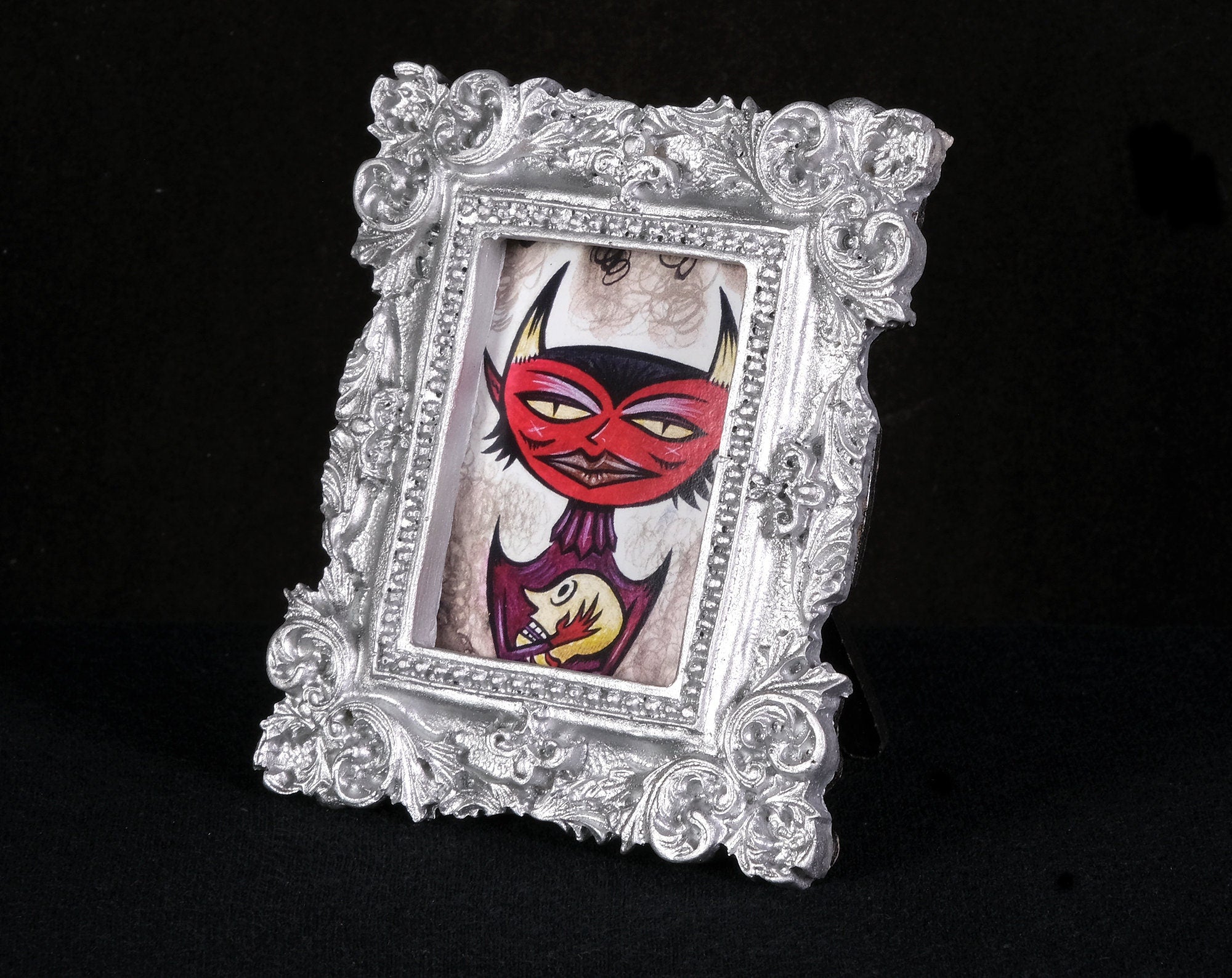 Head Holder Tiny Demon Framed Print
